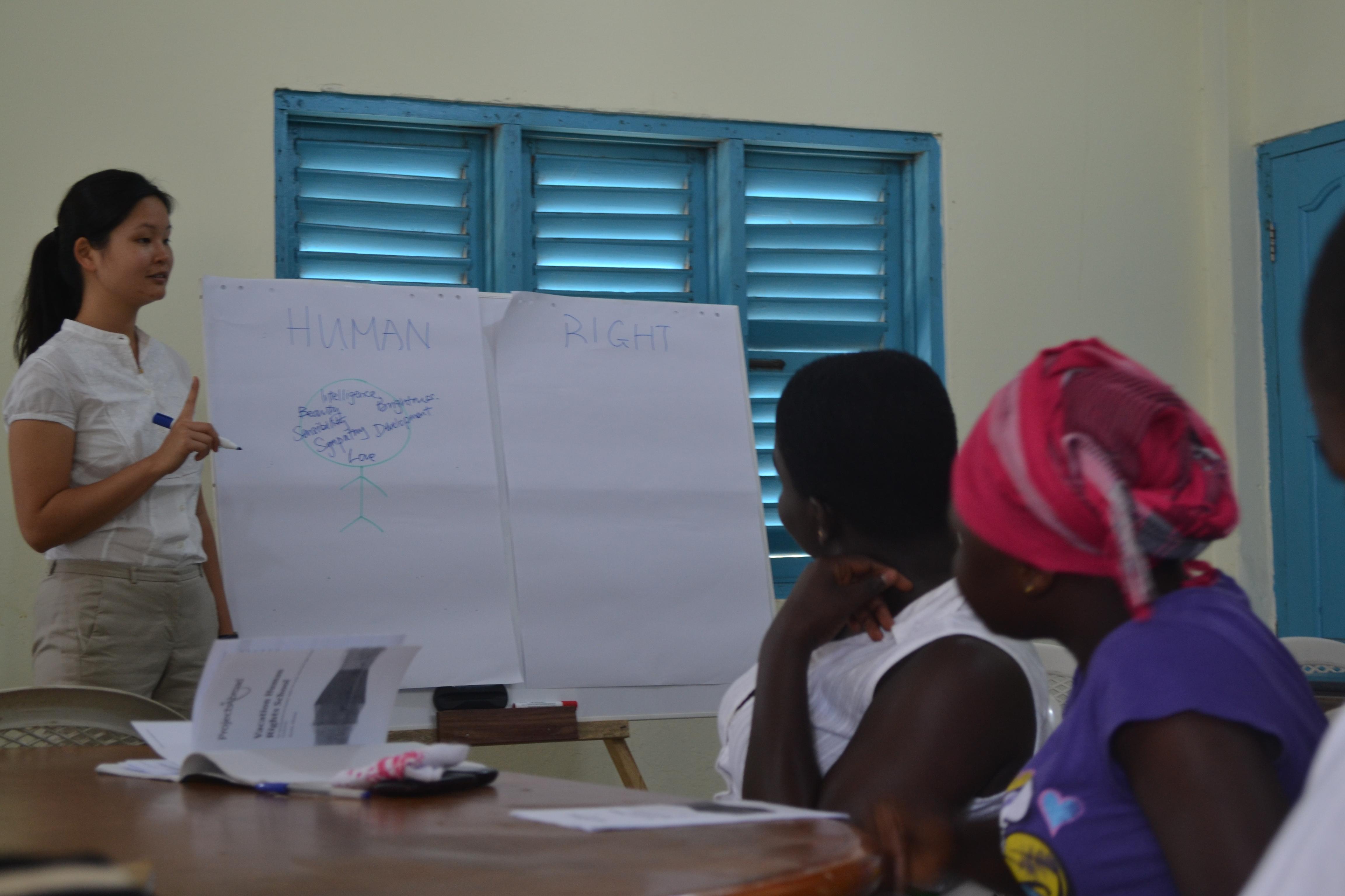 A Projects Abroad intern presents to woman during her Law work experience in Ghana. A student addresses woman during her Law internships in Ghana.